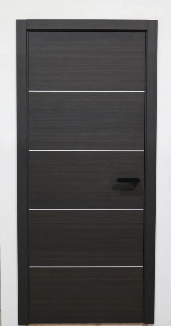 Daegu pre-hung door in wenge veneer with four inlay lines and a black handle