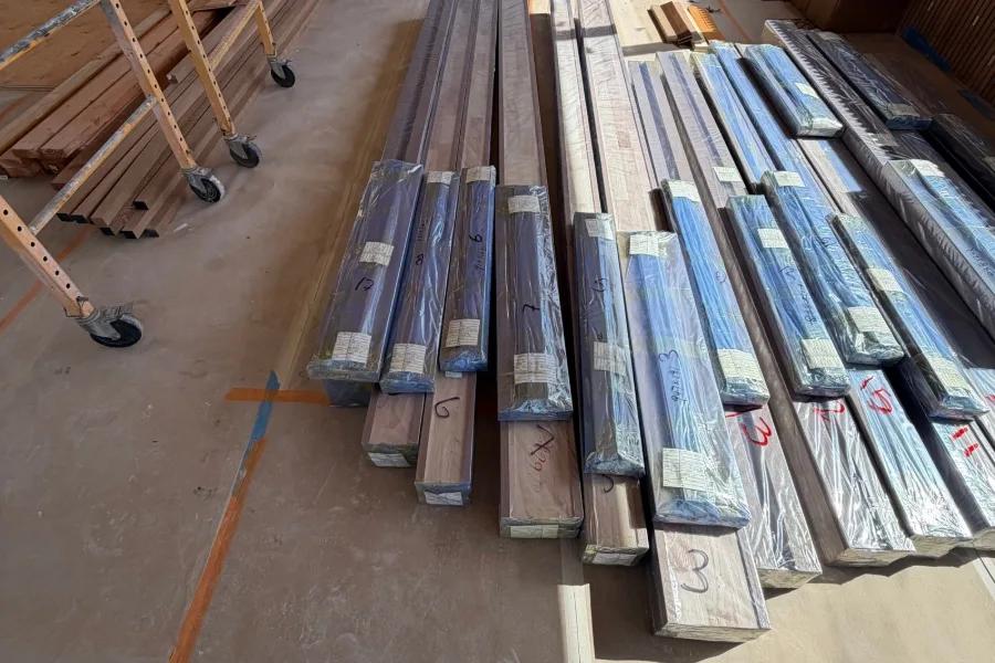 Pre-cut door frame parts, wrapped, laid out on site