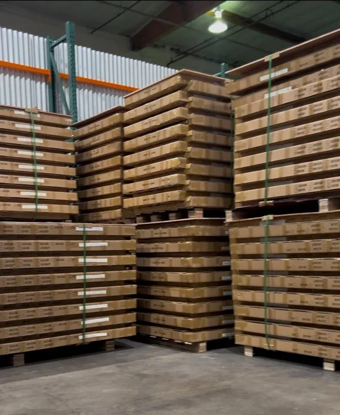 Pre-hung door sets boxed one per opening and stacked on pallets in a warehouse